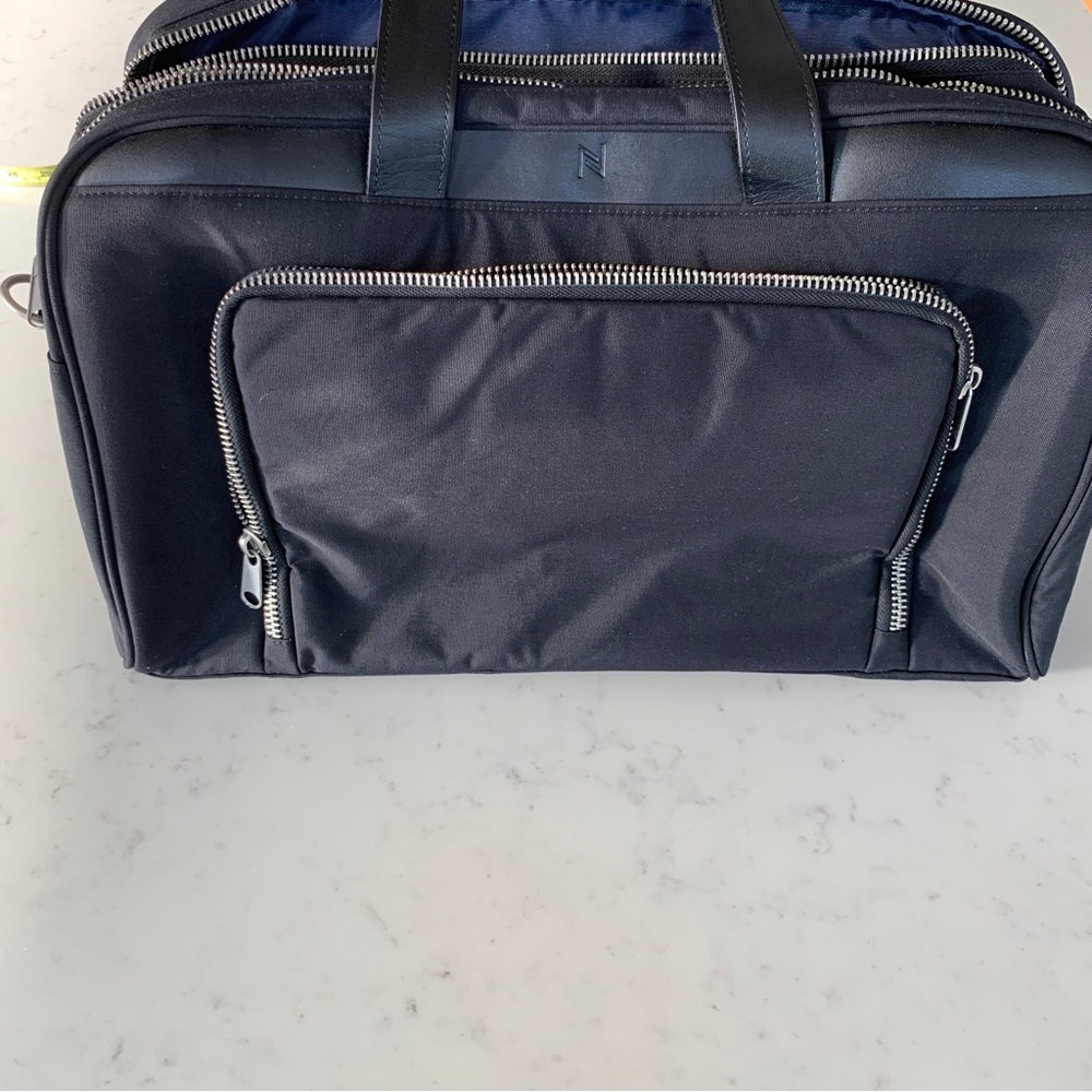 Black Travel Bag with Structured Design and Metal Feet - Picture 10 of 16